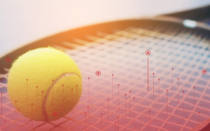 close up image of a tennis ball sitting on a racket