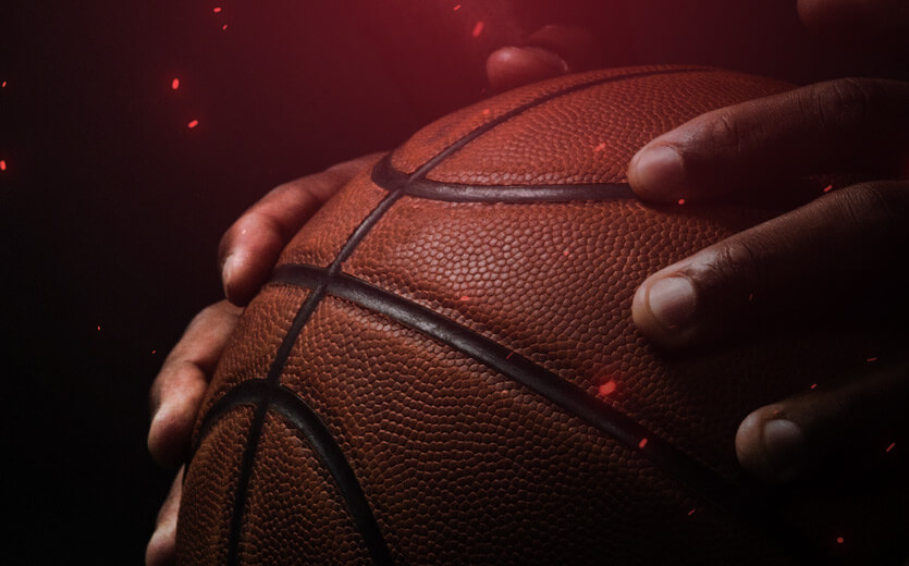 close up shot of hands holding a basketball