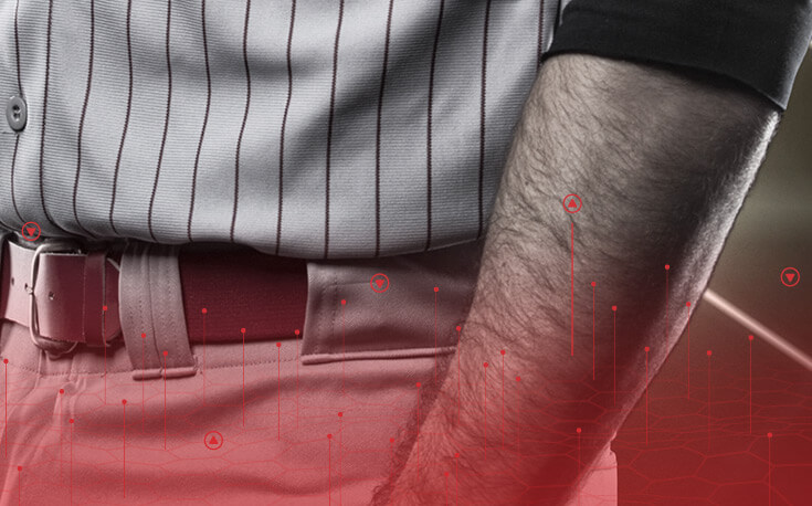 close up image of the shirt, arm and belt of a baseball player in uniform