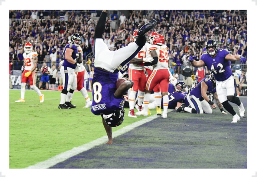 Lamar Jackson flipping into end zone with one hand 