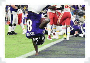 Lamar Jackson flipping into end zone with one hand 