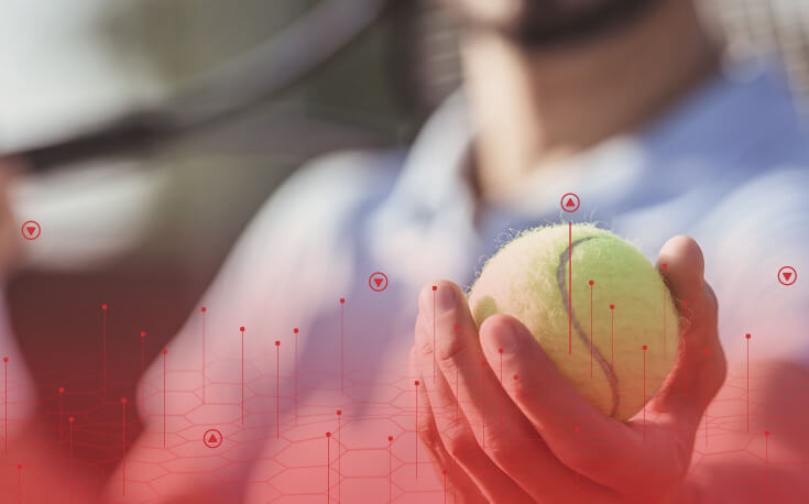 close up image of a hand holding a tennis ball