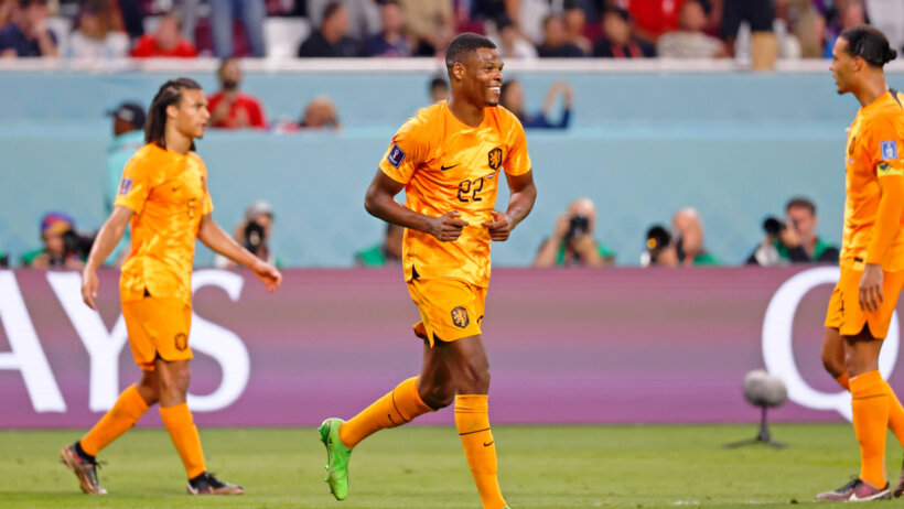 Netherlands defender Denzel Dumfries smiles after scoring a goal against the USA in the 2022 World Cup