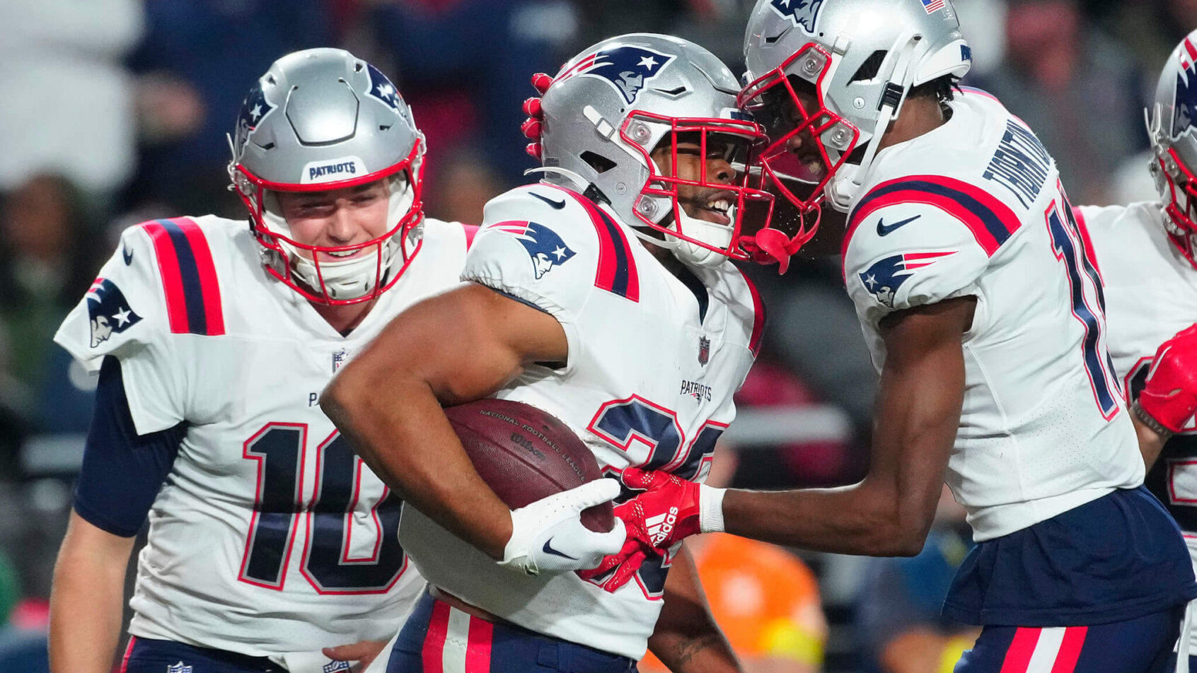 New England Patriots players celebrating touchdown white jerseys