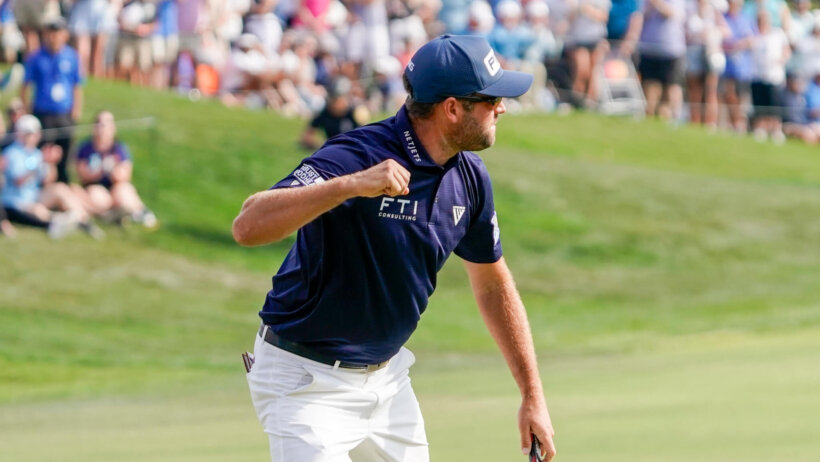 Corey Conners pumps his fist after draining a par putt