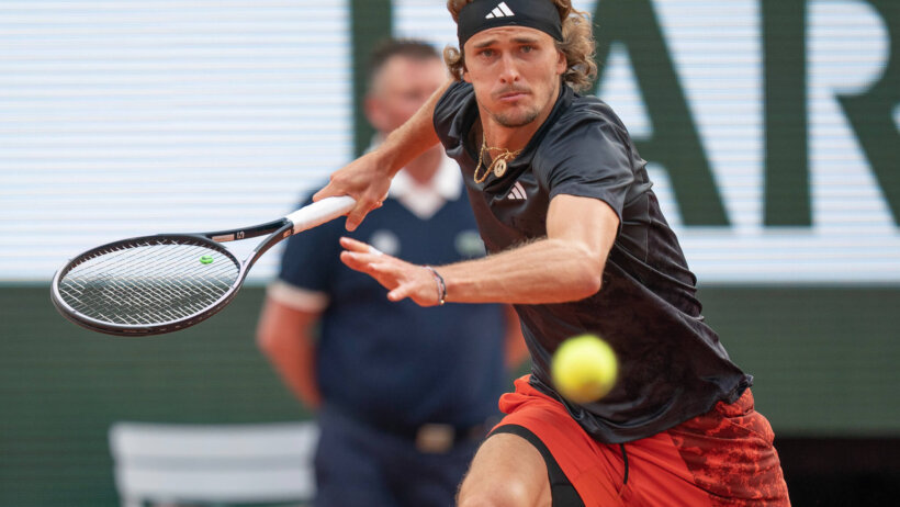 Alexander Zverev looking to return a ball during a tennis match.