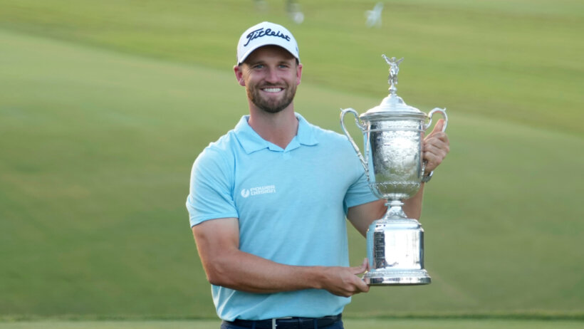 Wyndham Clark holding the championship trophy after winning the 2023 US Open