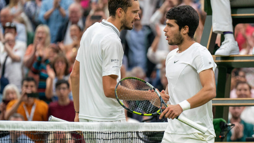 Carlos Alcaraz and Daniil Medvedev shaking hands after a match