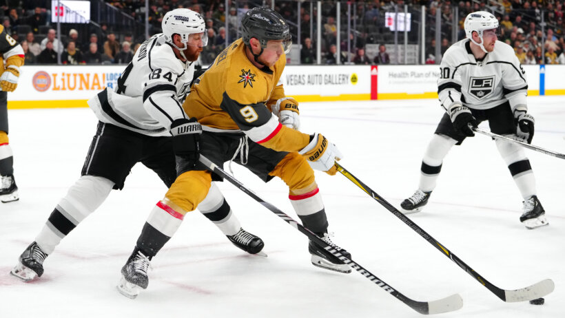 Vegas Golden Knights center Jack Eichel keeps the puck away from Los Angeles Kings defenseman Vladislav Gavrikov