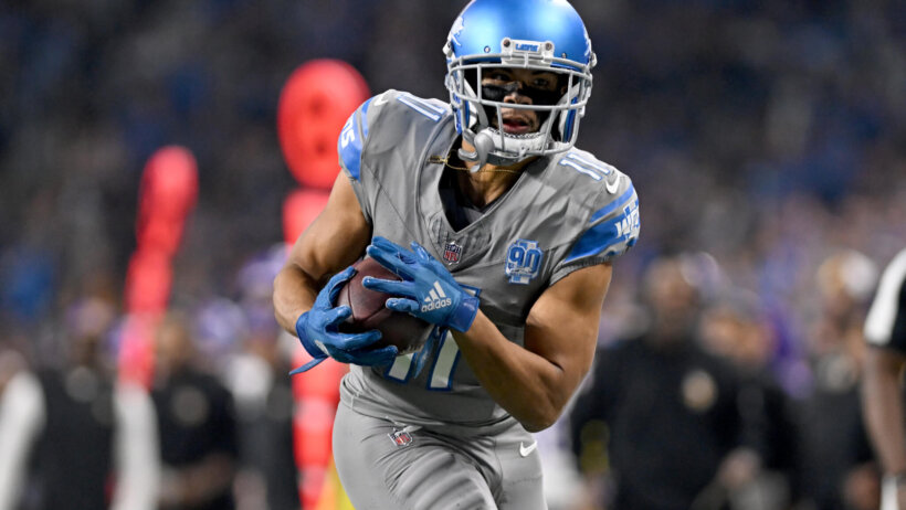 Detroit Lions wide receiver Kalif Raymond turns with the ball