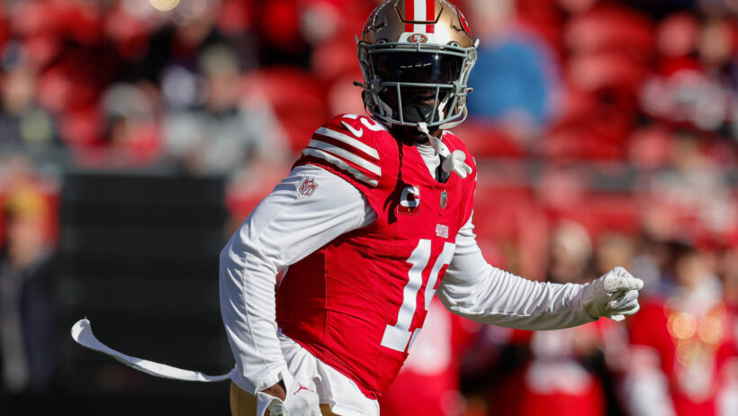 San Francisco 49ers player Deebo Samuel red jersey gold helmet