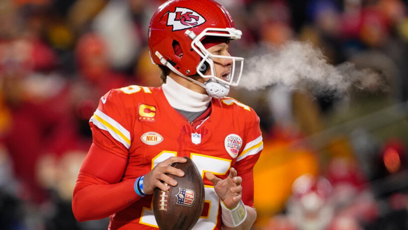 Patrick Mahomes preparing to throw football red jersey