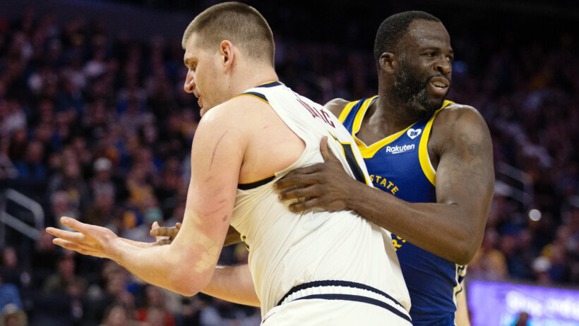 Golden State Warriors forward Draymond Green grabbing Denver Nuggets center Nikola Jokic