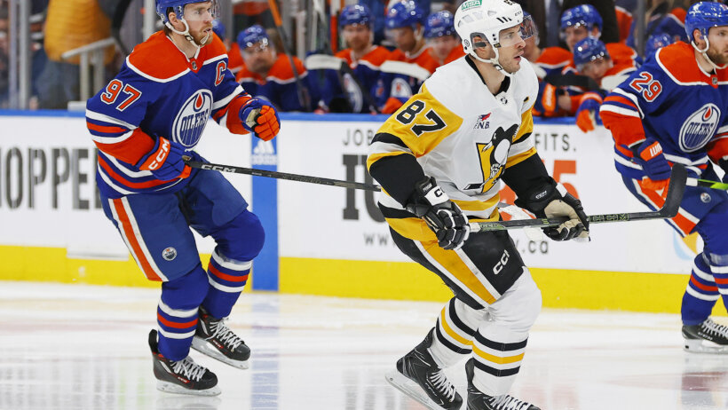 Pittsburgh Penguins forward Sidney Crosby and Edmonton Oilers forward Connor McDavid follow the play