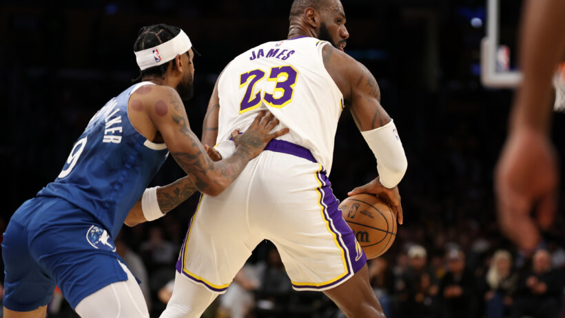 Los Angeles Lakers forward LeBron James posts up against Minnesota Timberwolves guard Nickeil Alexander-Walker