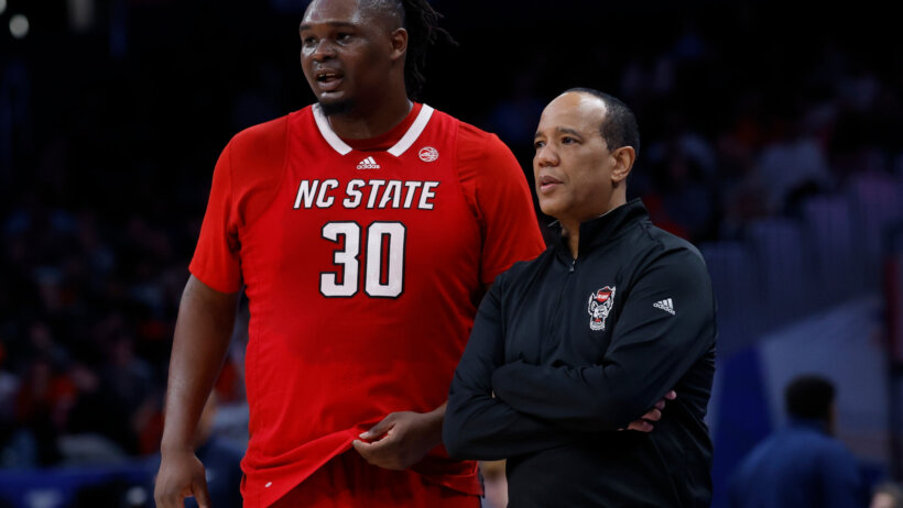 NC State basketball player and coach standing beside each other