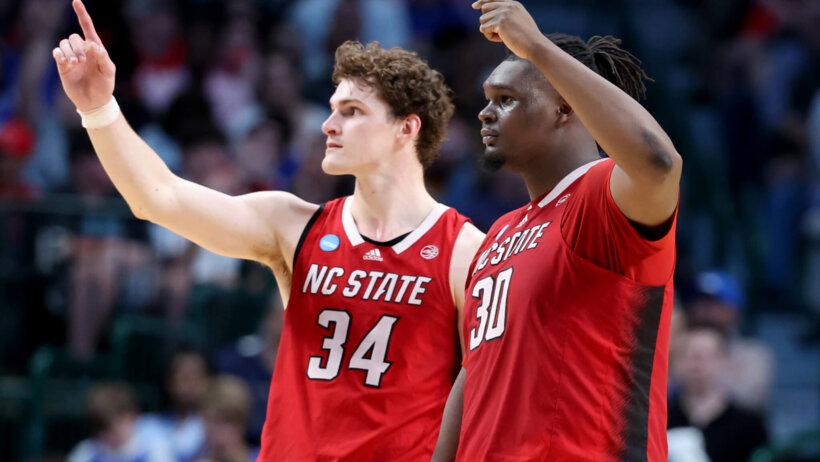 North Carolina State Wolfpack forward Ben Middlebrooks and center DJ Burns Jr gesture to the crowd