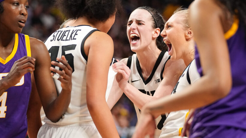 Iowa Hawkeyes players celebrating a basket