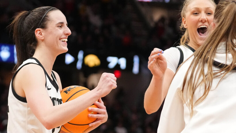 Iowa Hawkeyes guard Caitlin Clark celebrates with teammate Sydney Affolter