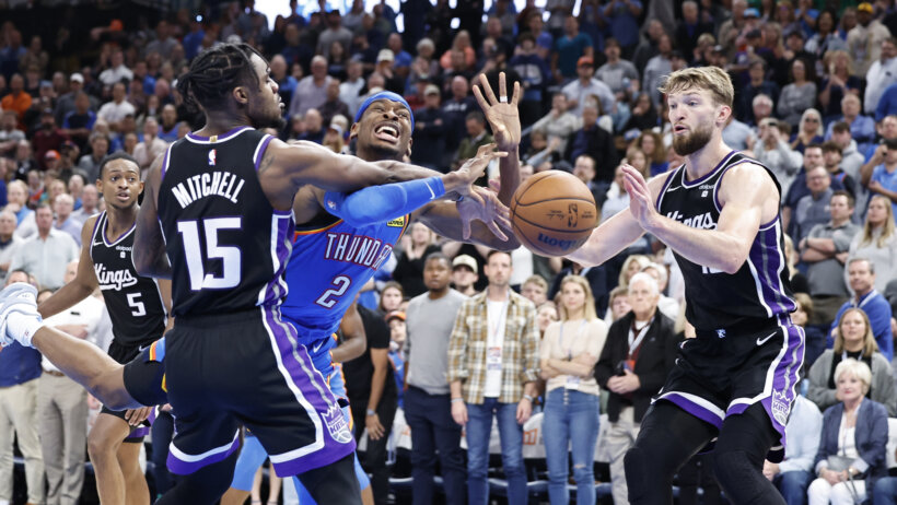 Oklahoma City Thunder guard Shai Gilgeous-Alexander battling with Sacramento Kings guard Davion Mitchell