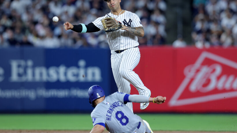 New York Yankees second baseman Gleyber Torres forces out Los Angeles Dodgers third baseman Enrique Hernandez at second base