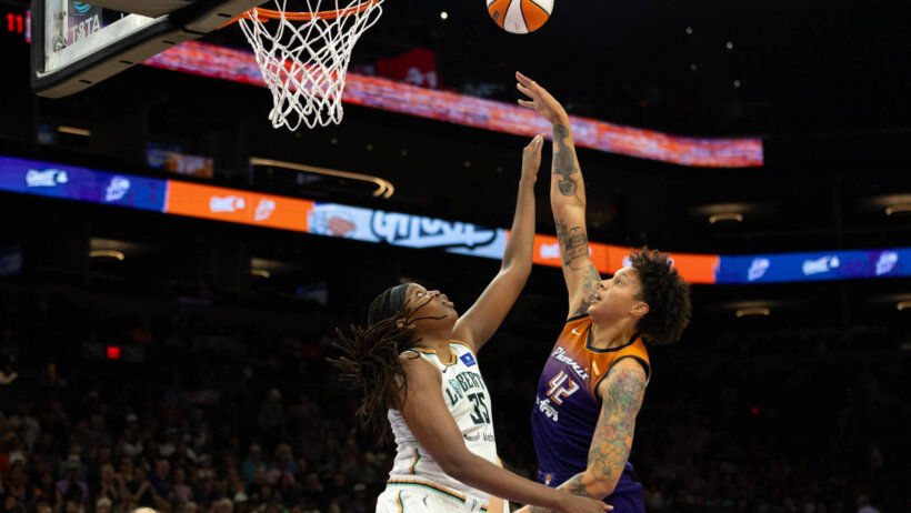 Phoenix Mercury center Brittney Griner shooting a hook shot over New York Liberty center Jonquel Jones