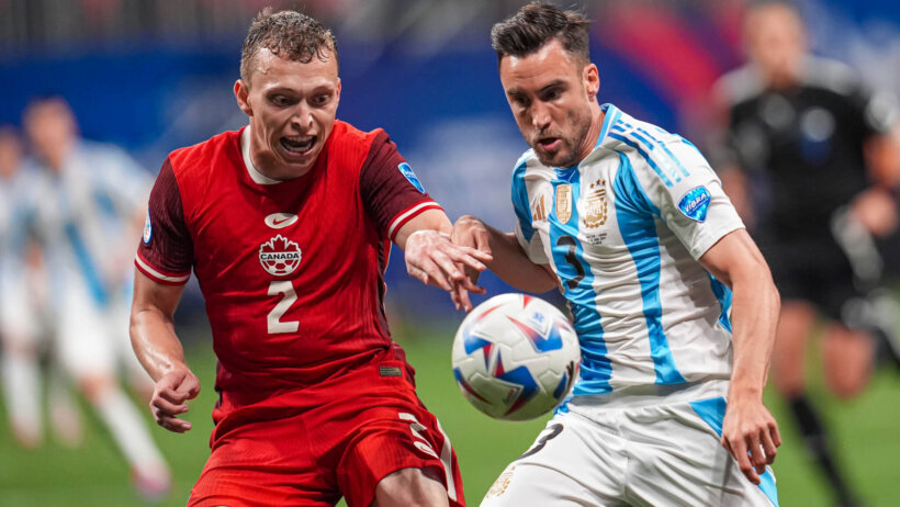 Canada defender Alistair Johnston and Argentina defender Nicolas Tagliafico battle for the ball