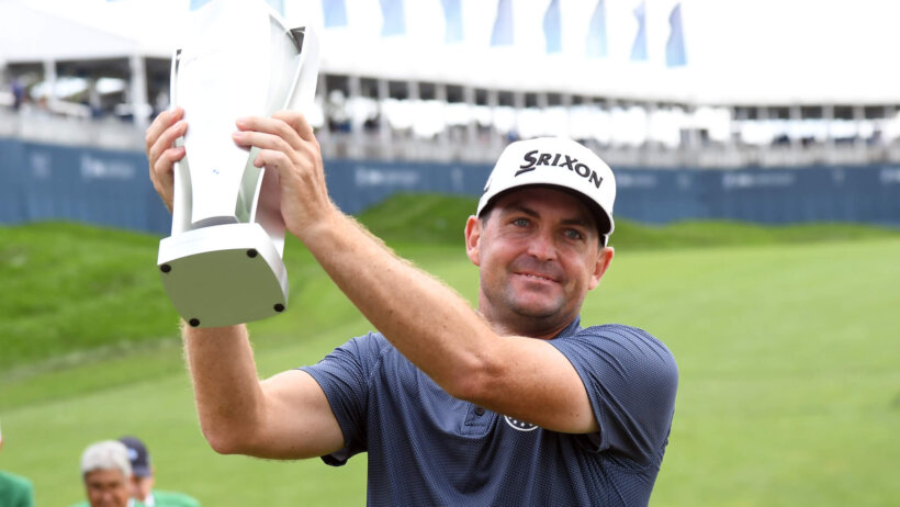 Keegan Bradley hoists the BMW Championship trophy after winning the tournament by 1 stroke.