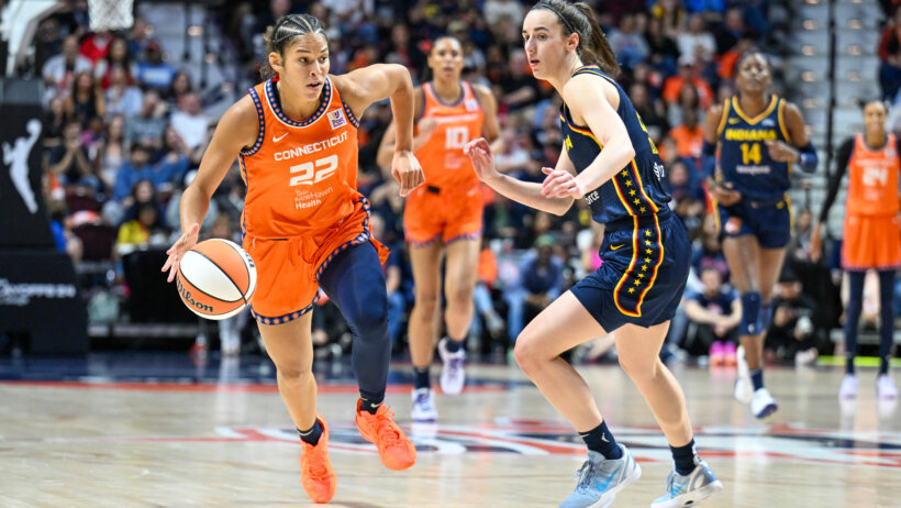 Connecticut Sun forward Alyssa Thomas dribbles the ball past Indiana Fever guard Caitlin Clark