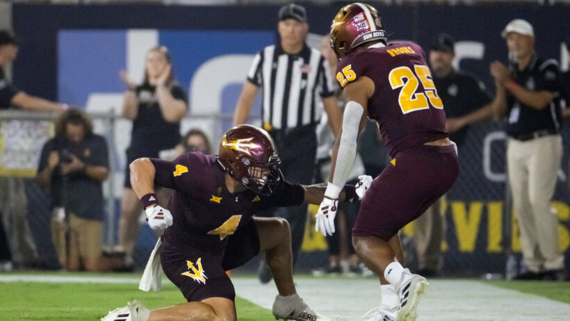 Arizona State running back Cam Skattebo celebrating after a touchdown with his teammate