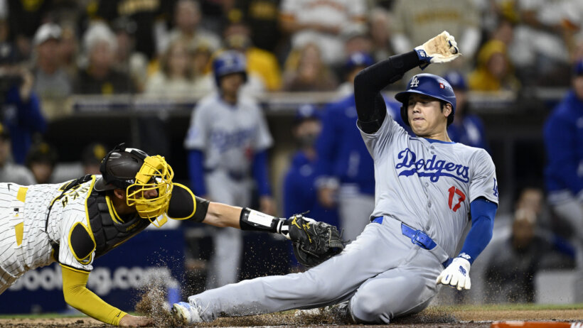 San Diego Padres catcher Kyle Higashioka tags Los Angeles Dodgers designated hitter Shohei Ohtani at home plate