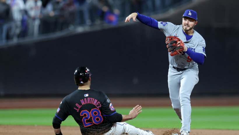 Los Angeles Dodgers second base Gavin Lux throws to first as New York Mets designated hitter J.D. Martinez slides into second base