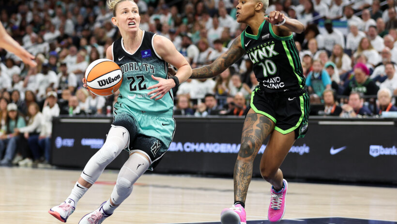 New York Liberty guard Courtney Vandersloot drives around Minnesota Lynx guard Courtney Williams