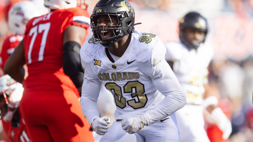 A Colorado Buffaloes football player celebrating by flexing his arms.