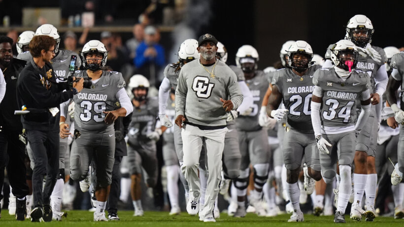 Coach Prime leads Colorado onto the field.