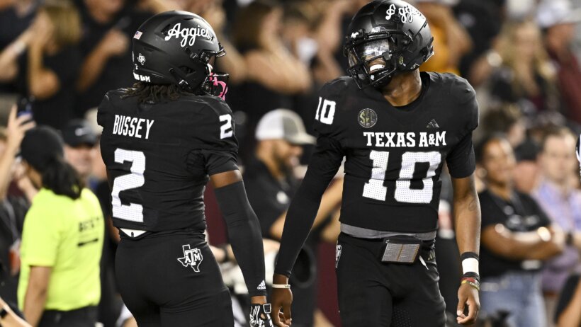 Marcel Reed celebrates with Rueben Owns.