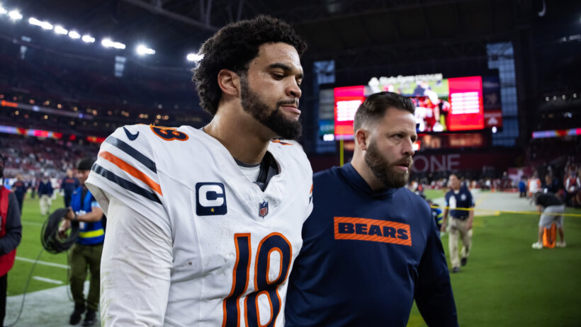 Caleb Williams being escorted off the field