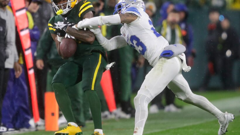 Green Bay Packers wide receiver Dontayvion Wicks tries to catch as pass as Detroit Lions cornerback Carlton Davis III defends