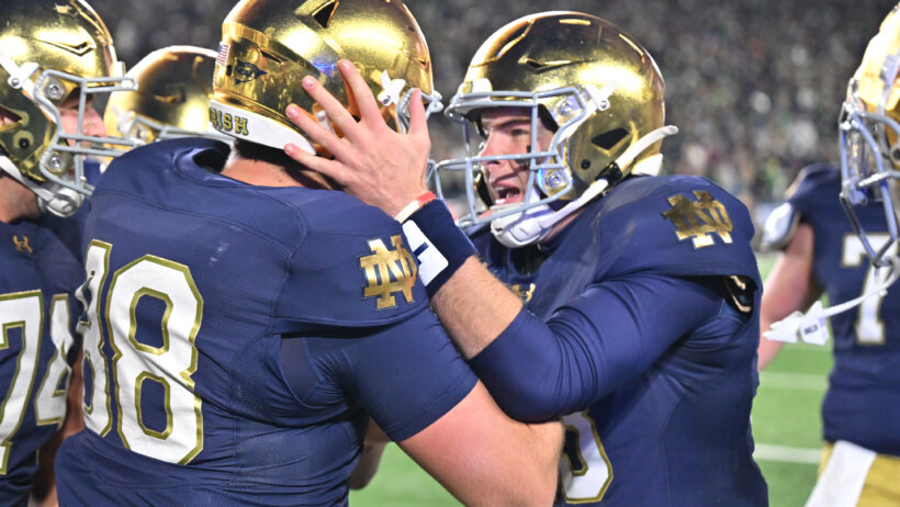 Notre Dame Fighting Irish football players celebrate scoring a touchdown.