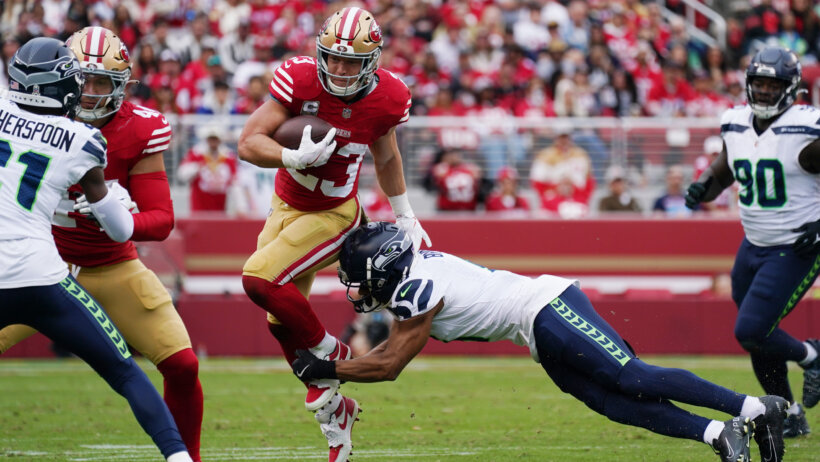 Christian McCaffrey running through tackle