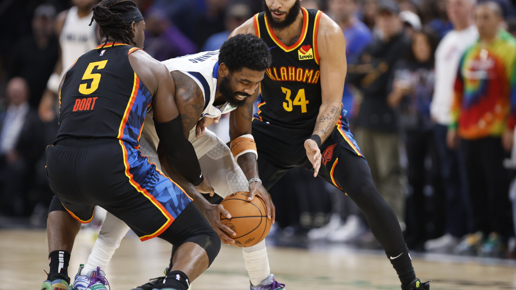 Dallas Mavericks guard Kyrie Irving battles for the ball against Oklahoma City Thunder guard Luguentz Dort