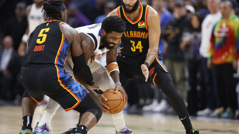 Dallas Mavericks guard Kyrie Irving battles for the ball against Oklahoma City Thunder guard Luguentz Dort