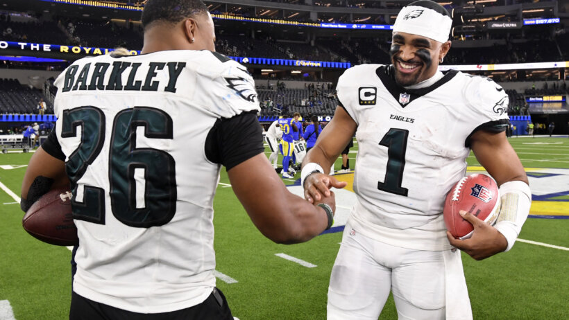 Saquon Barkley and Jalen Hurts shaking hands after a win