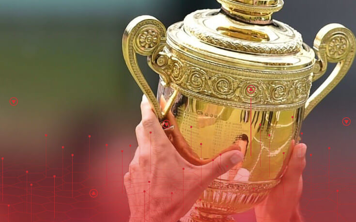 close up image of hands holding up the wimbledon men's trophy