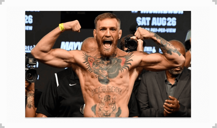 Conor McGregor flexing at a UFC weigh in