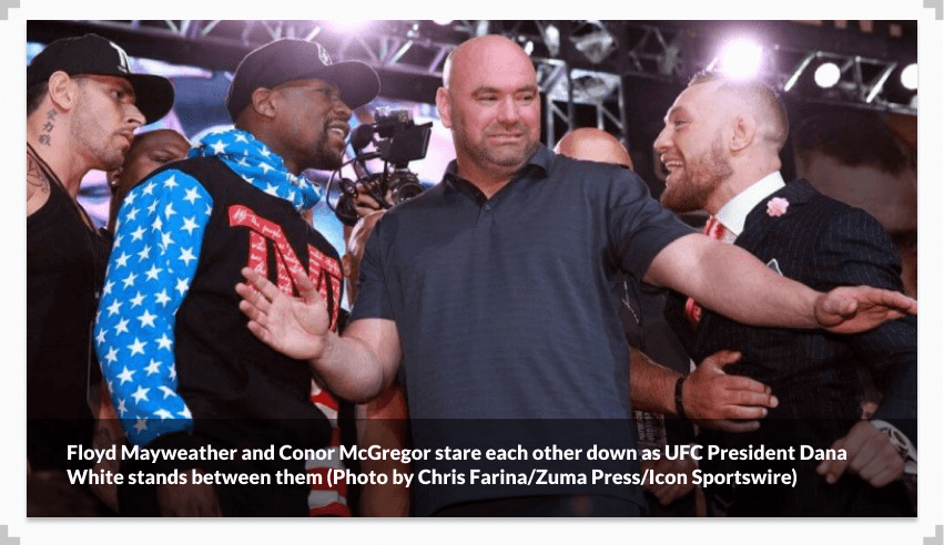 Floyd Mayweather and Conor McGregor stare each other down as UFC President Dana White stands between them